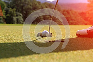 Golf clubs and golf ball in golf course