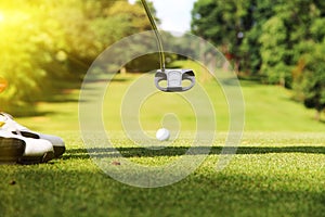 Golf clubs and golf ball in golf course