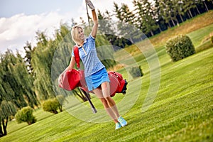 Golf concept, copy space. Women golf time holding golf equipment on green field background. The pursuit of excellence