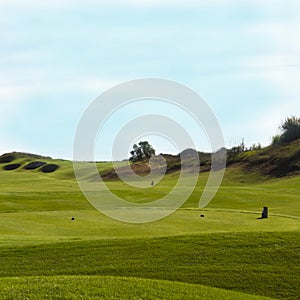 Golf course in Belek. Green grass on the field. Blue sky, sunny