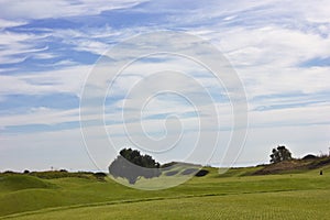 Golf course in Belek. Green grass on the field. Blue sky, sunny