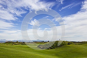 Golf course in Belek. Green grass on the field. Blue sky, sunny