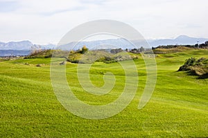 Golf course in Belek. Green grass on the field. Blue sky, sunny