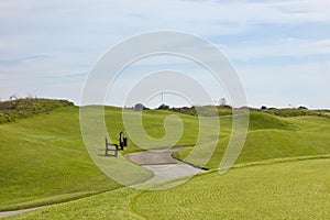 Golf course in Belek. Green grass on a field. Blue sky, sunny da