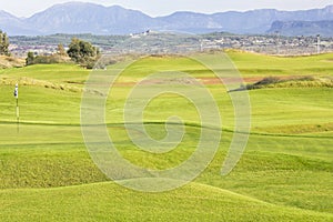 Golf course in Belek. Green grass on a field. Blue sky, sunny da