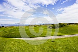 Golf course in Belek. Green grass on the field. Blue sky, sunny