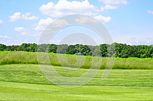 Golf course and cloudy blue sky