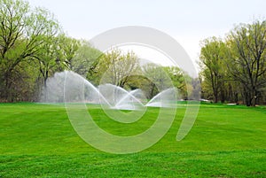 Golf course fairway being watered photo