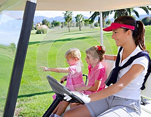 Golf course family mother and daughters in buggy