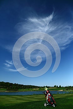 A golf course with a golfbag photo