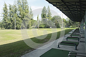 Golf course and golfballs on driving range,view of a golf course