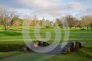 Golf course green with foot bridge over stream