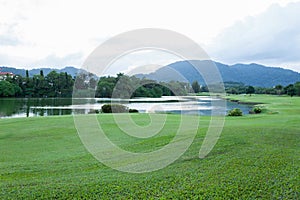 Golf course green grass field and lagoon