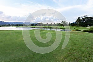 Golf course green grass field and lagoon