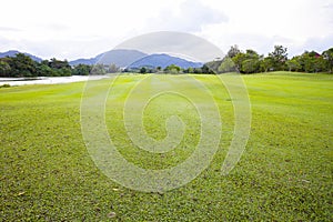 Golf course green grass field and lagoon.