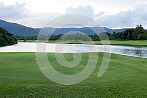 Golf course green grass field and lagoon.