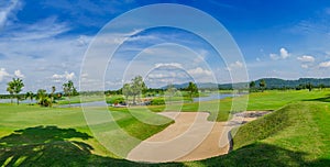 Golf course green under blue cloud sky for scene background