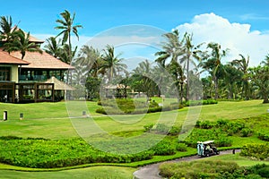 Golf course in luxury resort. Green field and blue sky