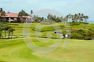 Golf course in luxury resort. Green field and blue sky