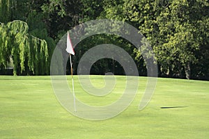 Golf course with no people. White flag in a resort golf club.