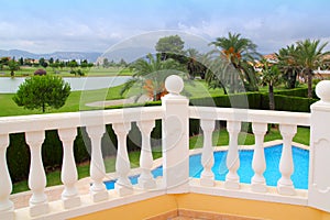 Golf course from pool housel white balustrade photo