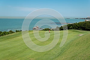Golf course with the sea in the background