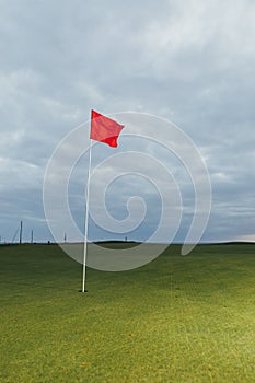 Golf course and red pin flag