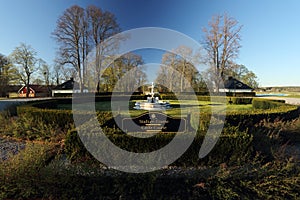 A golf course with roads and ponds and with golfcart and building in Sweden