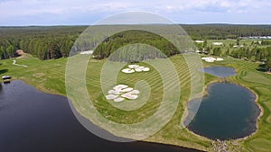 Golf course on a Sunny day, an excellent Golf club with ponds and green grass, view from the sky