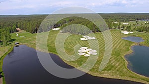 Golf course on a Sunny day, an excellent Golf club with ponds and green grass, view from the sky