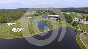 Golf course on a Sunny day, an excellent Golf club with ponds and green grass, view from the sky