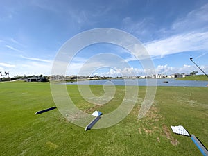 Golf Driving Range Grass Tee with Golf Balls and Blue Skies. In Florida Sun