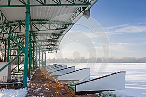 Golf driving range in winter. Snow scene, with blue cloud sky background