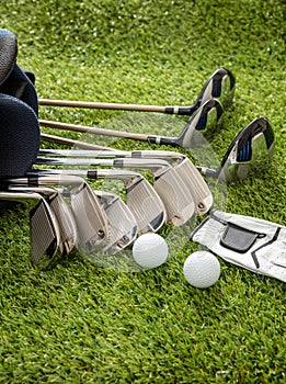 Golf equipment on green grass golf course, close up view