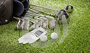 Golf equipment on green grass golf course, close up view