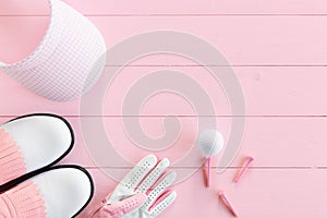 Golf equipment for ladies on a wooden surface in pink, top view photo