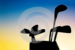 Golf equipment silhouett, clubs at sunset