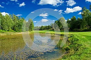 Golf fairway along a pond