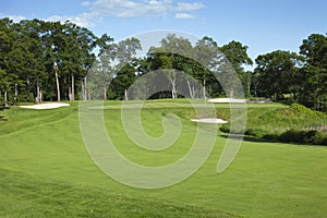 Golf fairway and green with bunkers photo
