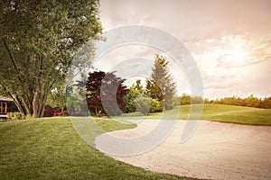 Golf fairway at sunset.