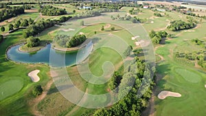 Golf field. Green golf course with small lake and trees. Relax time, sport concept. Recreation leisure activity. Golf club with go