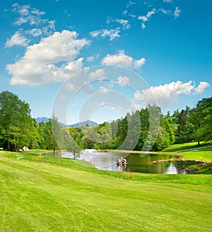 Golf field. Landscape with green grass and beautiful blue sky