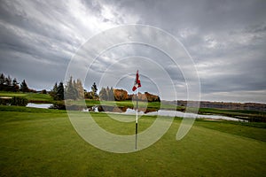 golf flag on a green in the fall