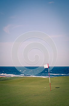 Golf flag overlooking the ocean