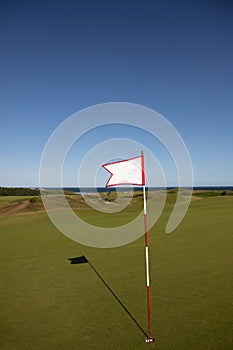 Golf flag overlooking the ocean