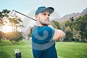Golf, focus and hobby with a sports man swinging a club on a field or course for recreation and fun. Golfing, grass and