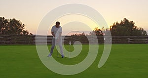 Golf game. Golfer putting golf ball in the hole rejoices.