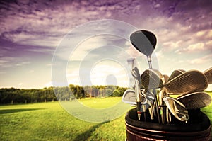 Golf gear, clubs at sunset