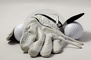 Golf glove, tees, and a golf ball