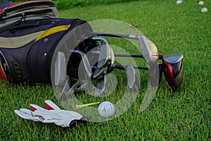 Golf glove , white golf ball on tee in a beautiful golf course